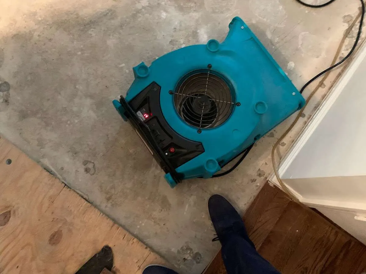 Air mover drying subfloor during Leak Detection & Repair in De Queen